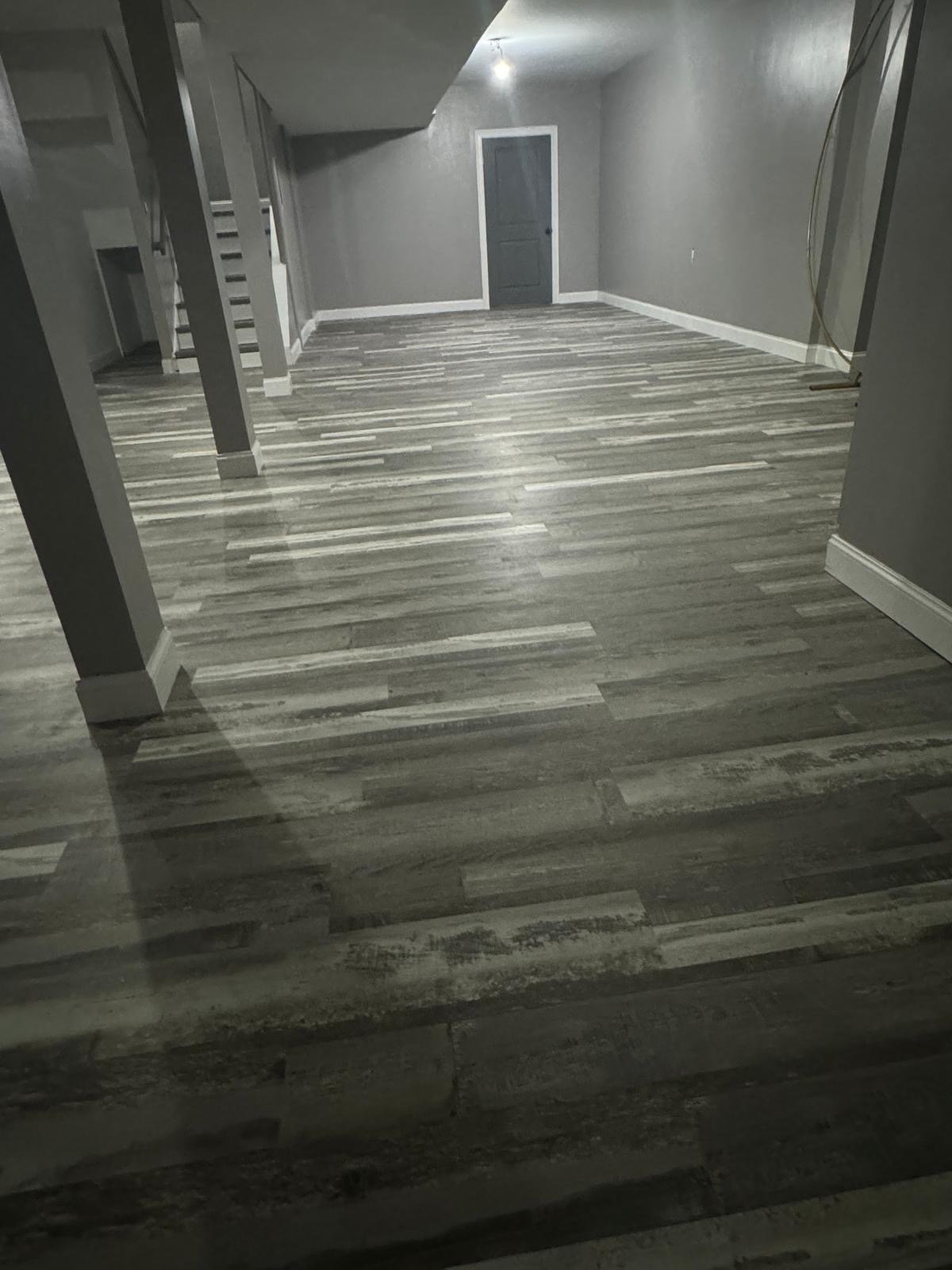 Finished basement renovation with updated flooring and layout